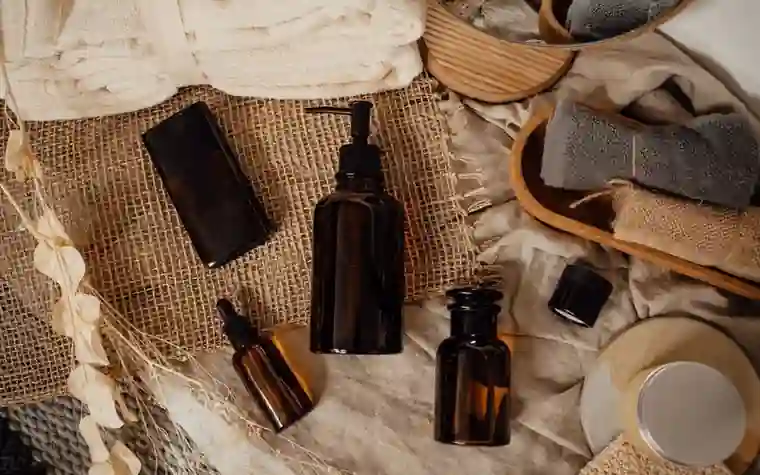 Amber skincare bottles arranged on a natural linen surface