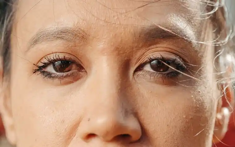 Extreme close-up of a woman's eyes and under-eye area