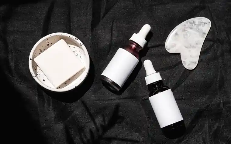 Overhead flatlay of skincare serums and cosmetic products