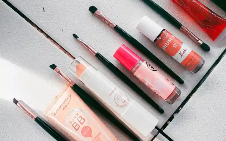 Flatlay of skincare and makeup products with brushes