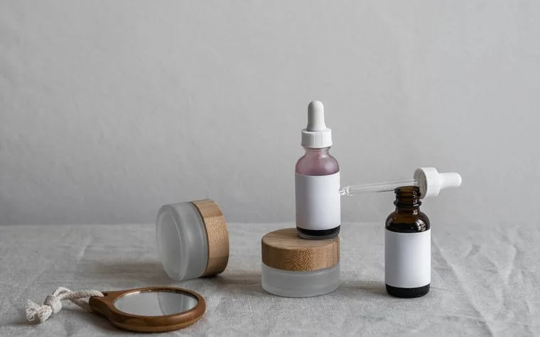 A dropper bottle of facial oil serum on a marble surface