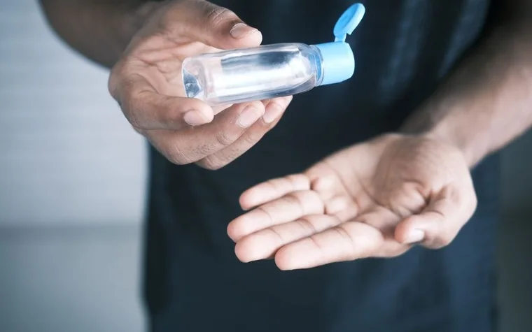 Close-up of a hand dispensing gel from a pump bottle