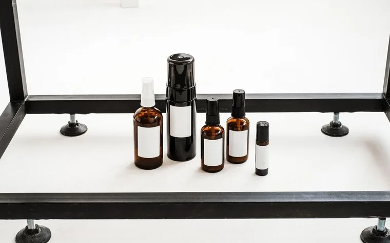 Minimalist flat lay of skincare bottles on a display stand