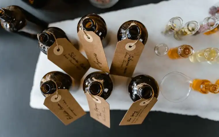 Small amber glass bottles with handwritten tags arranged on a table