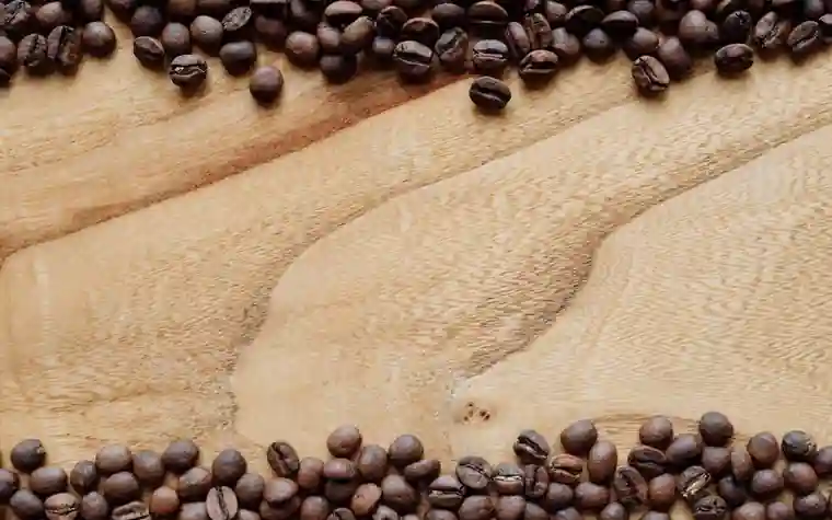 Coffee beans scattered on a wooden surface