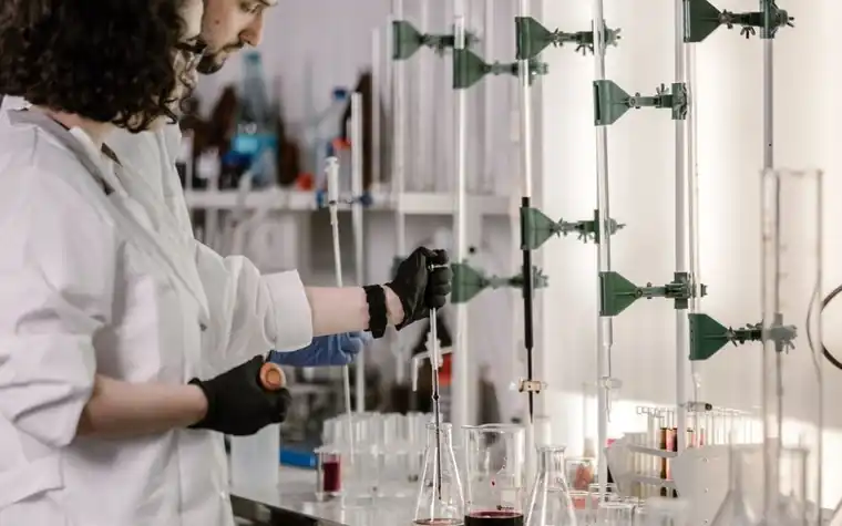 Scientists in lab coats working with test tubes