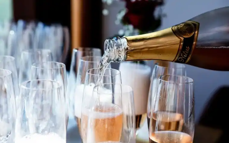 Champagne being poured into a glass with rising bubbles