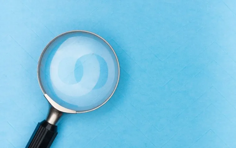 Magnifying glass lying on a flat blue surface