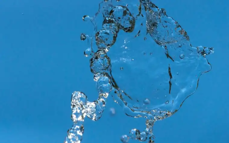 Blue water splashing against a bright background
