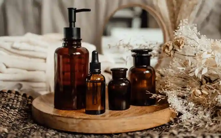 Amber dropper bottles and skincare jars arranged on a tray