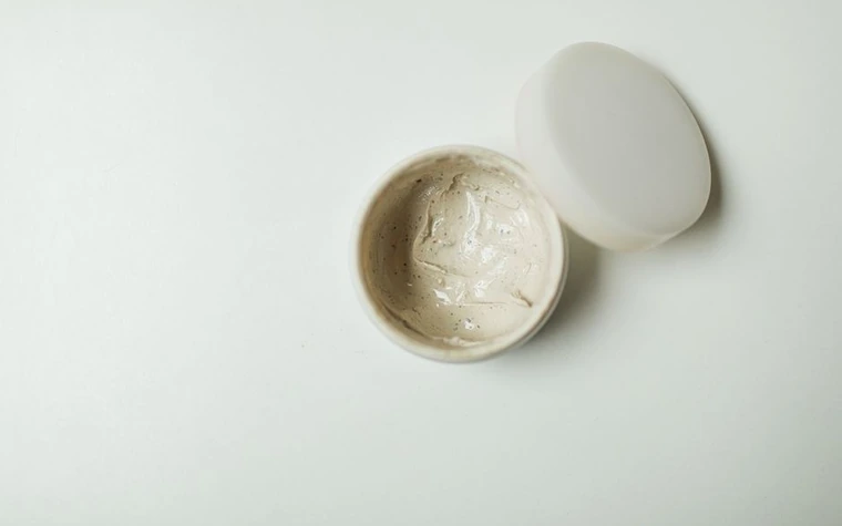 An open jar of white cream photographed from above
