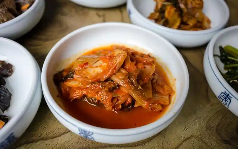 Bowl of spicy Korean kimchi stew with visible red chili
