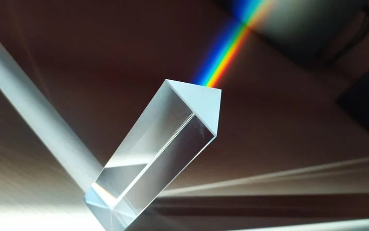 A glass prism refracting white light into a rainbow spectrum