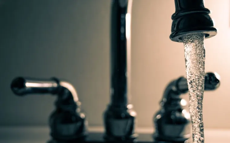 Water running from a faucet into a bathroom sink