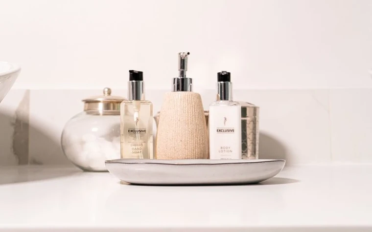 Skincare bottles arranged on a bathroom counter
