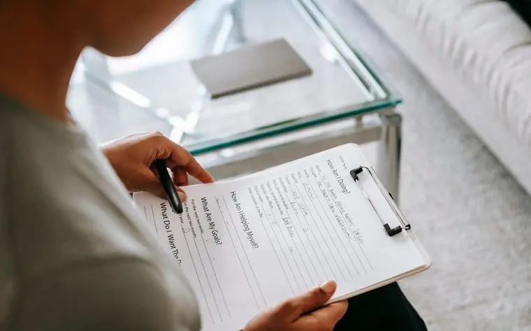 Skincare products and a questionnaire on a table for skin type assessment