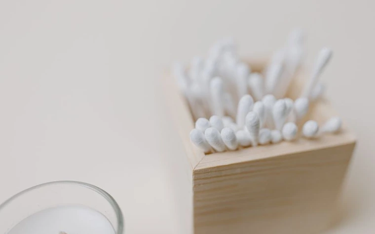 Cotton swabs arranged neatly in a wooden holder