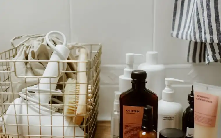A tidy bathroom shelf holding a small number of skincare products