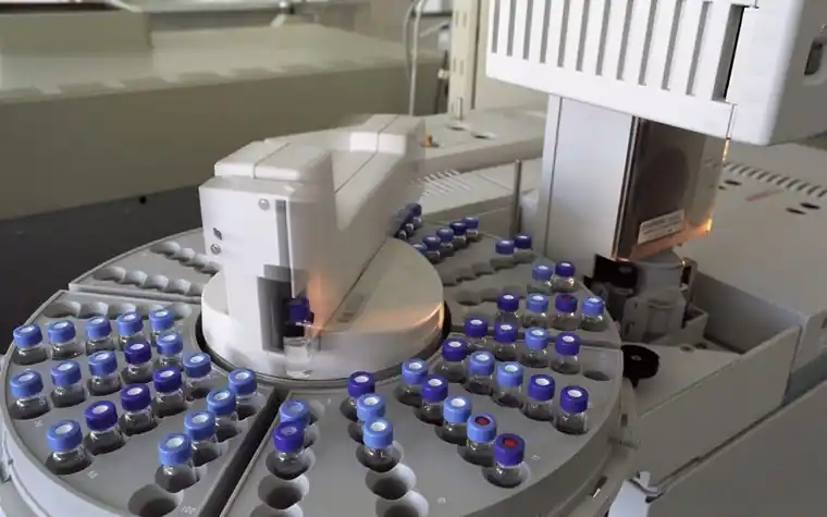 Rows of glass sample vials on a laboratory analyzer