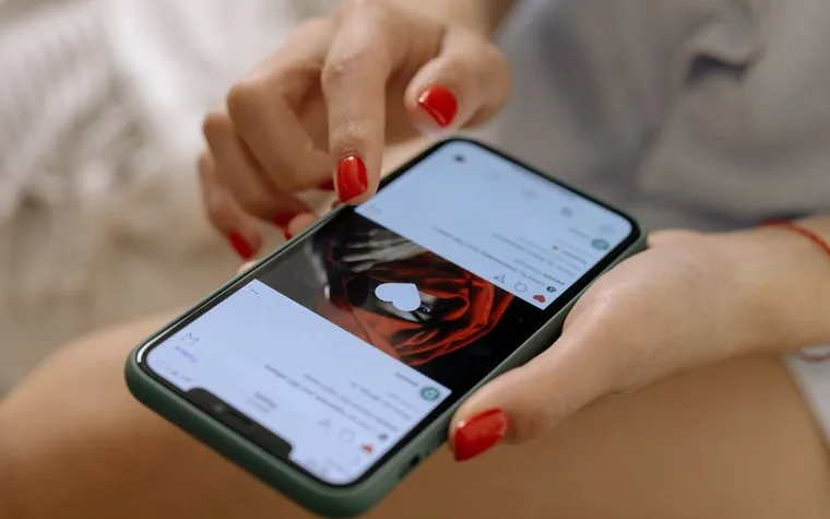 A person scrolling a social media feed on a smartphone