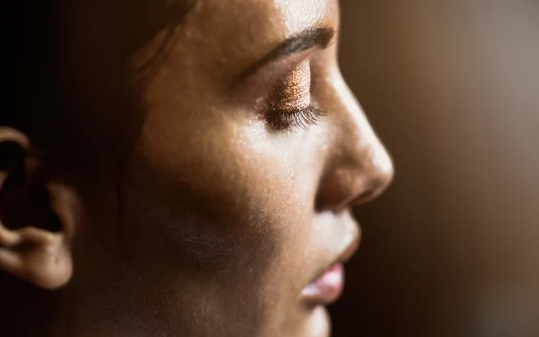 Side profile close-up of a woman's face showing skin texture